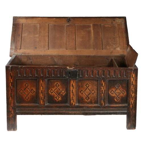 176 - A JAMES I OAK AND INLAID COFFER, CIRCA 1620. Having a quadruple-panelled lid, the front again with f... 