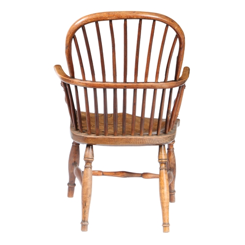 179 - A GEORGE III YEW WOOD AND ELM WINDSOR ARMCHAIR, CIRCA 1800. The arched top rail above spindles and a... 