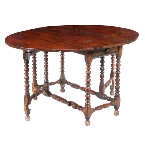 180 - AN 18TH CENTURY YEW WOOD GATELEG TABLE. The oval drop leaf top above a single frieze drawer to eithe... 