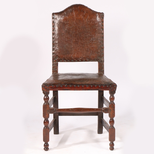 182 - A 17TH CENTURY OAK AND HIDE UPHOLSTERED SIDE CHAIR, LONDON. Having a serpentine-arched padded back, ... 