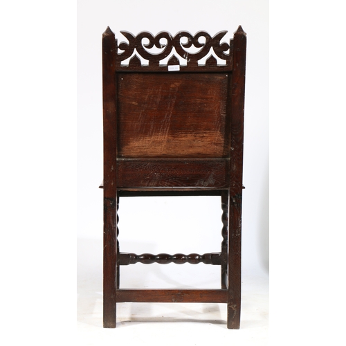 183 - AN UNCOMMON CHARLES II OAK BACKSTOOL, CHESHIRE, CIRCA 1680. The back panel carved with a large carna... 