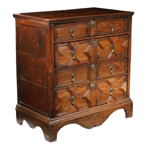 189 - A CHARLES II ELM GEOMETRIC CHEST OF DRAWERS, CIRCA 1660. The rectangular top above four long moulded... 