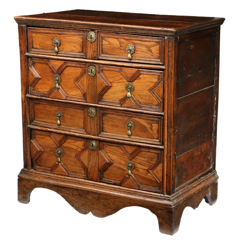 189 - A CHARLES II ELM GEOMETRIC CHEST OF DRAWERS, CIRCA 1660. The rectangular top above four long moulded... 