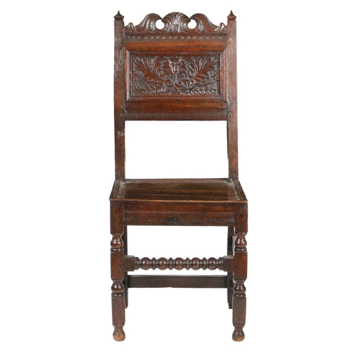 192 - A CHARLES II OAK BACKSTOOL, CIRCA 1680. The back panel typically carved with a single carnation flow... 