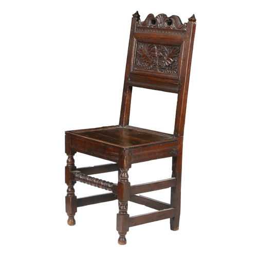 192 - A CHARLES II OAK BACKSTOOL, CIRCA 1680. The back panel typically carved with a single carnation flow... 