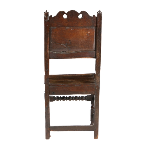 192 - A CHARLES II OAK BACKSTOOL, CIRCA 1680. The back panel typically carved with a single carnation flow... 