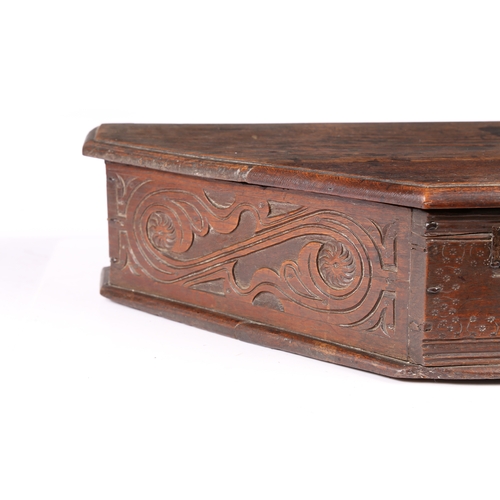 193 - A MID-17TH CENTURY OAK BOARDED TRIANGULAR-SHAPED BOX, ENGLISH, CIRCA 1640-60. The long sides leafy-s... 