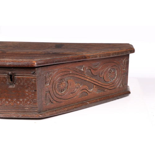 193 - A MID-17TH CENTURY OAK BOARDED TRIANGULAR-SHAPED BOX, ENGLISH, CIRCA 1640-60. The long sides leafy-s... 