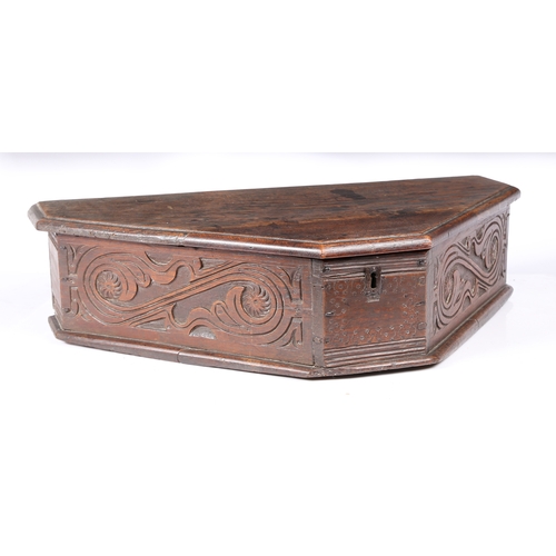 193 - A MID-17TH CENTURY OAK BOARDED TRIANGULAR-SHAPED BOX, ENGLISH, CIRCA 1640-60. The long sides leafy-s... 