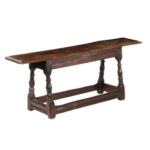 195 - A CHARLES II OAK FORM OR LONG BENCH, CIRCA 1660 AND LATER. The moulded rectangular top above channel... 