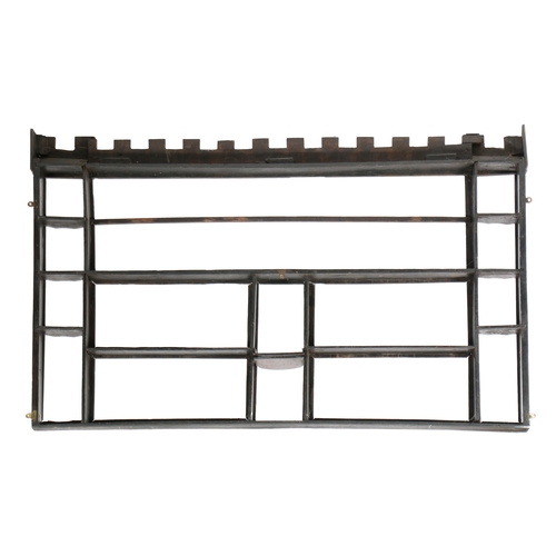 196 - AN OAK HANGING RACK, 18TH CENTURY TIMBERS. Having a castellated leaf-scroll carved frieze, three cen... 