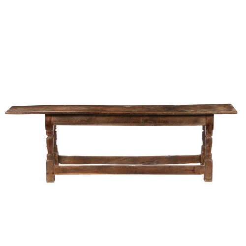 200 - A CHARLES I OAK FORM OR LONG BENCH, CIRCA 1640. The seat with moulded long edges and chip carved end... 