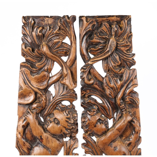 203 - A PAIR OF 18TH CENTURY LIMEWOOD CARVED MOUNTS (2). With putto above a stylised dolphin and leaf scro... 