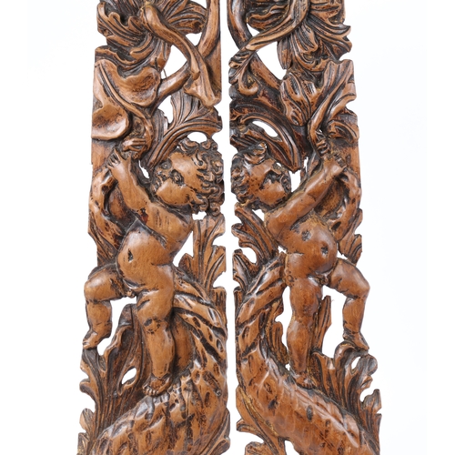 203 - A PAIR OF 18TH CENTURY LIMEWOOD CARVED MOUNTS (2). With putto above a stylised dolphin and leaf scro... 