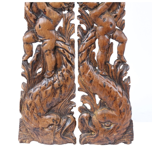 203 - A PAIR OF 18TH CENTURY LIMEWOOD CARVED MOUNTS (2). With putto above a stylised dolphin and leaf scro... 