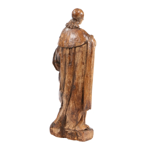 204 - A LARGE 17TH CENTURY WALNUT CARVED FIGURE. With long flowing hair below a skull cap, wearing a cape ... 