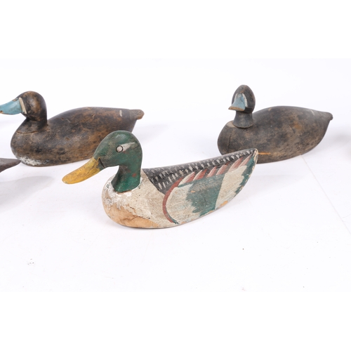 212 - FIVE POLYCHROME-DECORATED DECOY DUCKS. Each of typical naturalistic form, with coloured bill, two wi... 