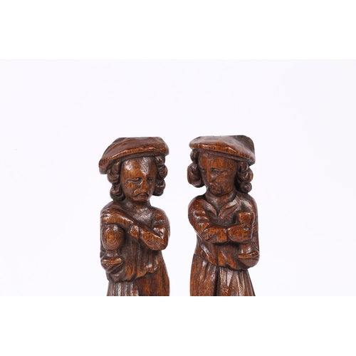 216 - A SMALL PAIR OF 17TH CENTURY OAK FIGURAL TERMS, FLEMISH. Each designed as a standing male, with long... 