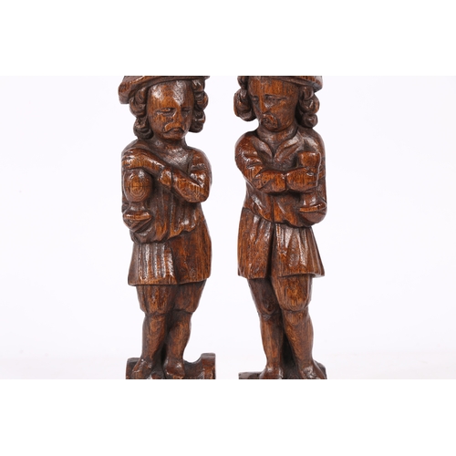 216 - A SMALL PAIR OF 17TH CENTURY OAK FIGURAL TERMS, FLEMISH. Each designed as a standing male, with long... 