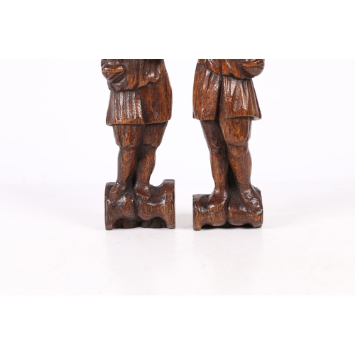 216 - A SMALL PAIR OF 17TH CENTURY OAK FIGURAL TERMS, FLEMISH. Each designed as a standing male, with long... 