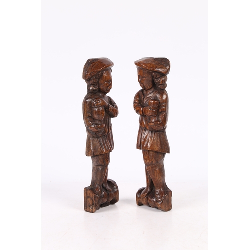 216 - A SMALL PAIR OF 17TH CENTURY OAK FIGURAL TERMS, FLEMISH. Each designed as a standing male, with long... 