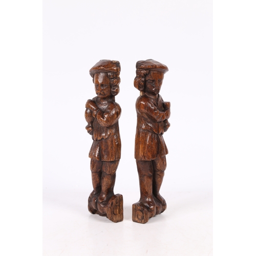 216 - A SMALL PAIR OF 17TH CENTURY OAK FIGURAL TERMS, FLEMISH. Each designed as a standing male, with long... 