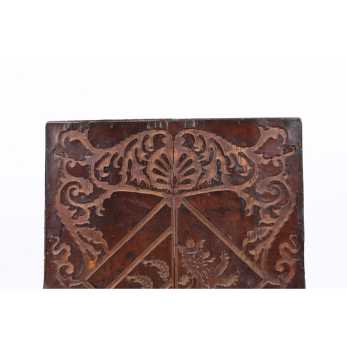 219 - A RARE 17TH CENTURY LEATHER-WORK ARMORIAL PANEL, ENGLISH. The cut-leather mounted on pine boards, de... 