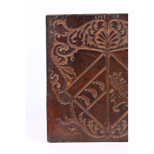 219 - A RARE 17TH CENTURY LEATHER-WORK ARMORIAL PANEL, ENGLISH. The cut-leather mounted on pine boards, de... 