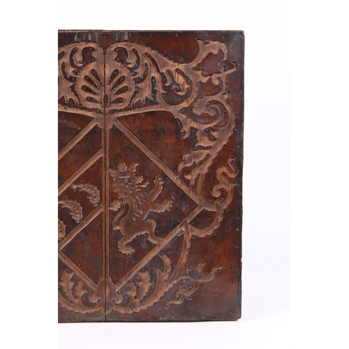 219 - A RARE 17TH CENTURY LEATHER-WORK ARMORIAL PANEL, ENGLISH. The cut-leather mounted on pine boards, de... 