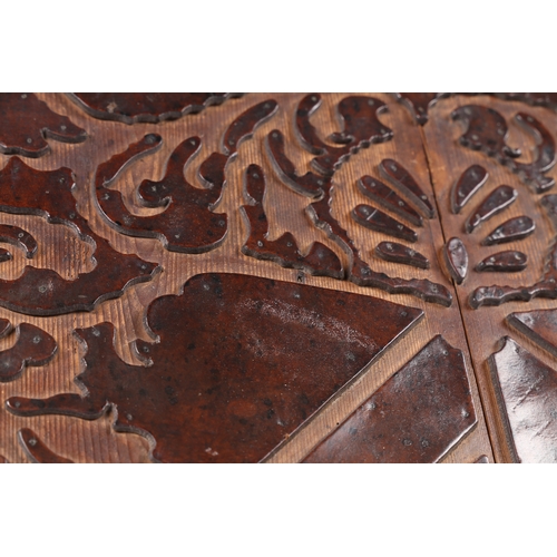 219 - A RARE 17TH CENTURY LEATHER-WORK ARMORIAL PANEL, ENGLISH. The cut-leather mounted on pine boards, de... 