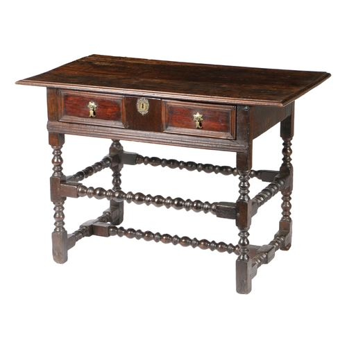 22 - A CHARLES II OAK SIDE TABLE. with a rectangular top above a frieze drawer, raised on bobbin turned l... 
