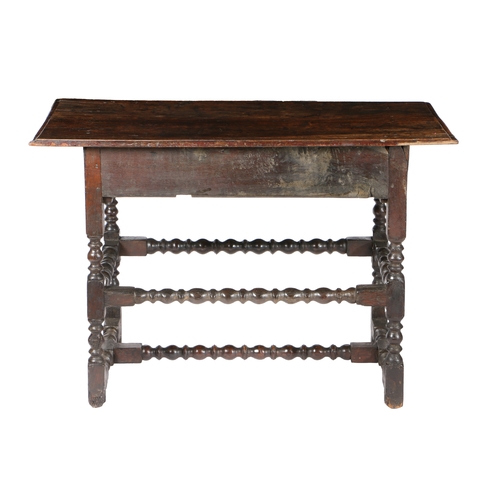 22 - A CHARLES II OAK SIDE TABLE. with a rectangular top above a frieze drawer, raised on bobbin turned l... 