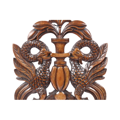 228 - A LARGE MAHOGANY PIERCED AND CARVED CRESTING PANEL, CIRCA 1830. Designed with paired cockatrice, cen... 