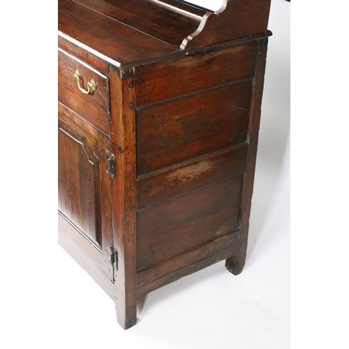 23 - AN 18TH CENTURY OAK DRESSER BASE. with a stepped pediment above two shelves raised on two drawers wi... 