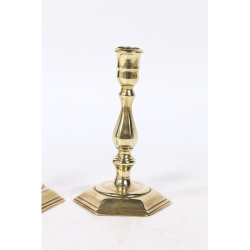 236 - A PAIR OF GEORGE I BRASS CANDLESTICKS. with a baluster stem raised on a hexagonal stepped base, 15cm... 