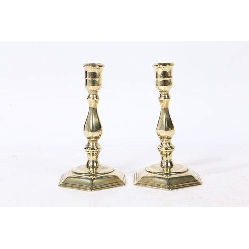 236 - A PAIR OF GEORGE I BRASS CANDLESTICKS. with a baluster stem raised on a hexagonal stepped base, 15cm... 