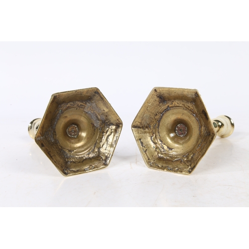 236 - A PAIR OF GEORGE I BRASS CANDLESTICKS. with a baluster stem raised on a hexagonal stepped base, 15cm... 