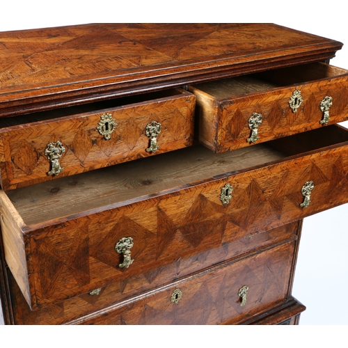 25 - AN UNUSUAL GEORGE I CHEST ON STAND, CIRCA 1725. Having a crossbanded top with cyma-recta under-edge,... 