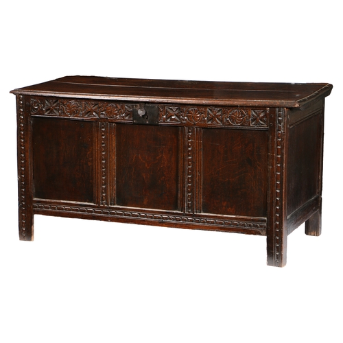 31 - A CHARLES I OAK COFFER, WEST COUNTRY, CIRCA 1640. Having a twin-boarded lid with ovolo-moulded edge,... 