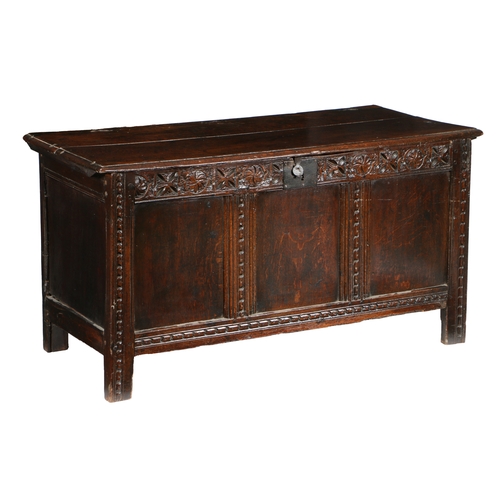31 - A CHARLES I OAK COFFER, WEST COUNTRY, CIRCA 1640. Having a twin-boarded lid with ovolo-moulded edge,... 