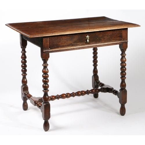 34 - A CHARLES II OAK SIDE TABLE, CIRCA 1680. Having a boarded top with moulded edge and single frieze dr... 