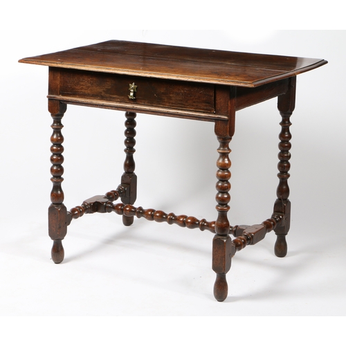 34 - A CHARLES II OAK SIDE TABLE, CIRCA 1680. Having a boarded top with moulded edge and single frieze dr... 