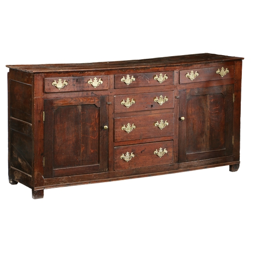 37 - AN 18TH CENTURY OAK DRESSER BASE. the rectangular top above six drawers and a pair of panelled cupbo... 