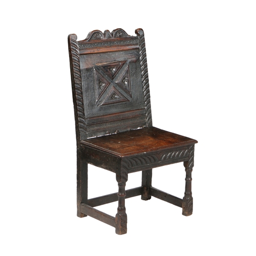 46 - A CHARLES I OAK BACKSTOOL, CIRCA 1640. The  back panel with a run-moulded saltire, each raised segme... 