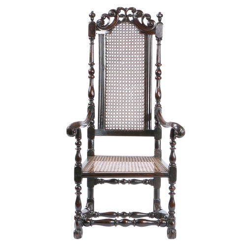 52 - A LATE 17TH CENTURY WALNUT AND CANE OPEN ARMCHAIR, ENGLISH, CIRCA 1685. Having an arched cane back, ... 