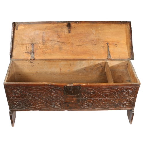 582 - A 17TH CENTURY OAK COFFER. The rectangular top with HC initials carved above a carved front panel wi... 