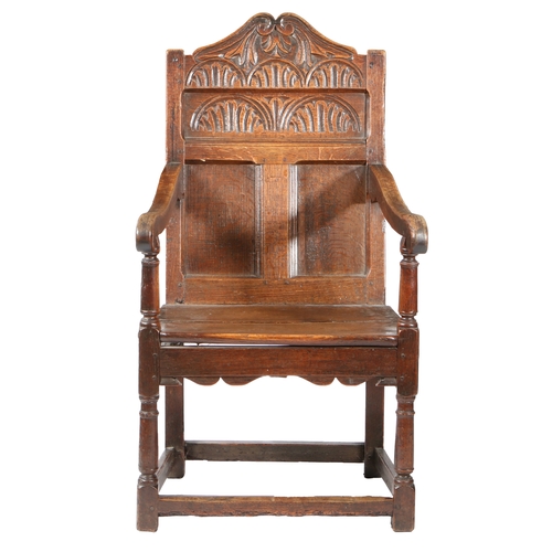 583 - A CHARLES II OAK TRIPLE-PANEL BACK OPEN ARMCHAIR, GLOUCESTERSHIRE, CIRCA 1660. The back with a slend... 