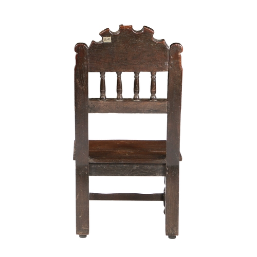 585 - A CHARLES II OAK BACKSTOOL, SOUTH YORKSHIRE, PROBABLY SHEFFIELD, CIRCA 1660. Having an arched cresti... 