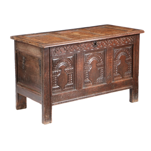 587 - A CHARLES I OAK COFFER, CIRCA 1640. Having a triple-panelled hinged lid and front, each front panel ... 