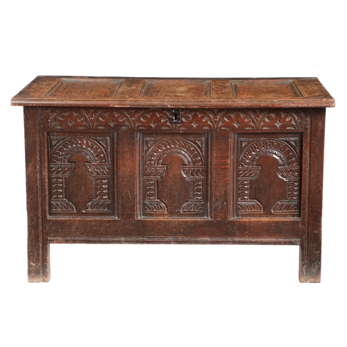 587 - A CHARLES I OAK COFFER, CIRCA 1640. Having a triple-panelled hinged lid and front, each front panel ... 